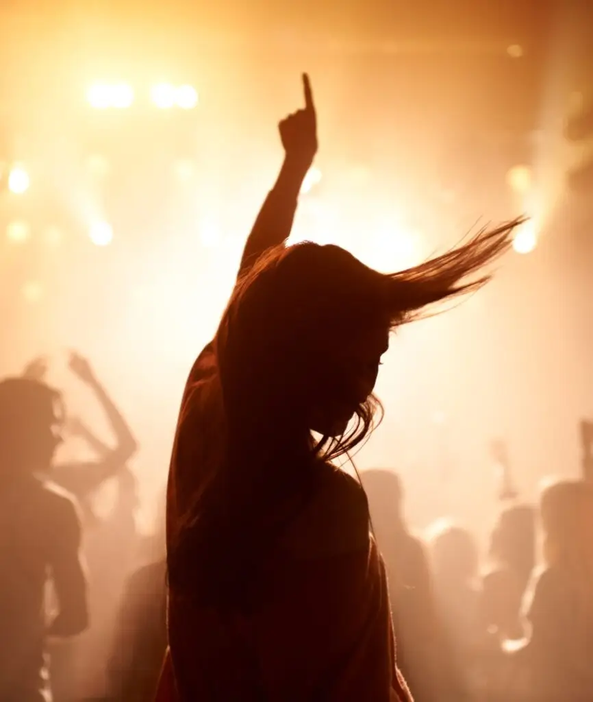 The most epic show of their lives. Young people getting into the music at an awesome concert.
